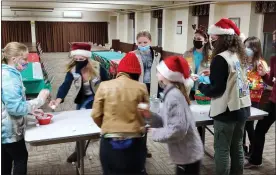  ?? SUBMITTED PHOTO ?? This photo shows Girl Scouts from Troops 71879, 71790 and 70621 playing games at a holiday gathering at St. Mark’s Lutheran Church in Pennsburg.