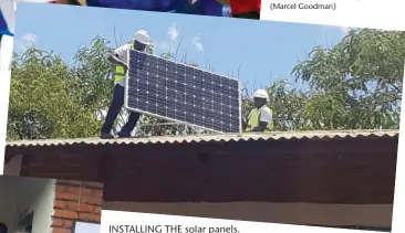  ??  ?? INSTALLING THE solar panels.