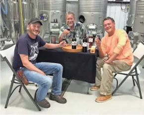  ?? JEREMY WILLIAMSON ?? Fementatio­n specialist Michael Jones (center) meets with Parallel 44 winery's vineyard manager/assistant winemaker Dan Raatz (left) and co-owner Steve Johnson.