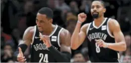  ?? NAM Y. HUH — THE ASSOCIATED PRESS ?? Brooklyn’s Rondae Hollis-Jefferson, left, and Spencer Dinwiddie celebrate against the Chicago Bulls on Wednesday in Chicago.