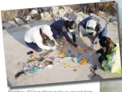  ??  ?? Members of Clean Hikers make an artwork from litter they collected while hiking. –