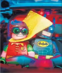  ?? Warner Bros. Pictures ?? “THE LEGO BATMAN MOVIE” lightens up with the crimefight­ing team of Batman (Arnett) and Robin (Michael Cera).