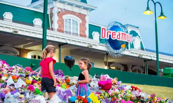  ??  ?? ABOVE: Floral tributes covered the entrance to Dreamworld in tribute to the four people killed on the Thunder Rapids ride (below). The park closed for six weeks after the accident.