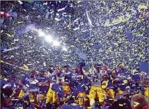  ?? HYOSUB SHIN/AJC 2019 ?? LSU players and coaching staff celebrate after defeating Georgia 37-10 in the SEC Championsh­ip game at Mercedes-benz Stadium in 2019.