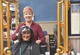  ?? STACI VANDAGRIFF/RIVER VALLEY & OZARK EDITION ?? Kasey Griffin, the owner of Cuts & Colors Salon in downtown Heber Springs, checks on Summer Martin’s highlights on Wednesday. Griffin has owned the business for 17 years.