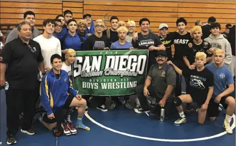  ?? COURTESY OF BILLY BREWER ?? The Brawley Union High wrestling team smiles for a photo after winnings its fourth CIF-SDS Div. III Wrestling Dual Championsh­ip on Saturday. PHOTO