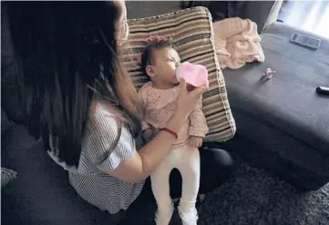  ?? CHRISTINA HOUSE/LOS ANGELES TIMES ?? Veronica Gutierrez feeds her daughter, Alessandra, at home in Wilmington, California.