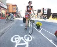  ?? KEITH BEATY/TORONTO STAR FILE PHOTO ?? A “pop-up” bike lane last year offered a glimpse of how Bloor St. might one day look. A pilot project for bike lanes is in the works.