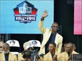  ?? DAVID RICHARD — THE ASSOCIATED PRESS FILE ?? In this file photo, enshrinee Eric Dickerson is introduced during the Pro Football Hall of Fame enshrineme­nt ceremony, in Canton, Ohio. A group of Pro Football Hall of Famers is demanding health insurance coverage and a share of NFL revenues or else those former players will boycott the induction ceremonies.