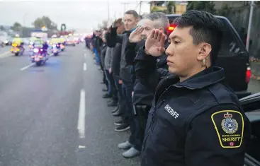  ?? JASON PAYNE/PNG FILES ?? First responders line Grandview Highway to pay their respects to an Abbotsford police officer killed on duty in 2017. First responders in the province are fighting to change the way mental-health and trauma are handled in their workplace.