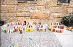  ??  ?? Memorial candles grace a space near the Bronx building where Gabriel Casso (right) lived before he was gunned down Saturday by two men in a crime that was observed by three cops who subsequent­ly shot at the men, injuring one and arresting both.