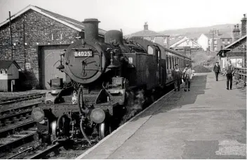  ??  ?? Bolton-based Standard Class 2 2-6-2 tank No. 84025 stands at Horwich station with the 4.57pm for Chorley on August 16, 1965. The train then returned to Horwich empty stock, before making a further run to Chorley at 5.47pm. These trains were run for workers from the nearby ex-L&Y railway Works.