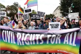  ?? Photograph: Jonathan Ernst/Reuters ?? LGBTQ+ activists and supporters block the street outside the US supreme court in Washington DC as it hears arguments in a major LGBTQ+ rights case.