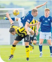  ??  ?? Queens’ Daniel Pybus challenges Dumbarton’s Stuart Carswell