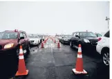  ?? COURANT FILE ?? Residents receive their COVID-19 vaccinatio­ns at the old Pratt & Whitney Airport runway near Rentschler Field on Feb. 9 in East Hartford.