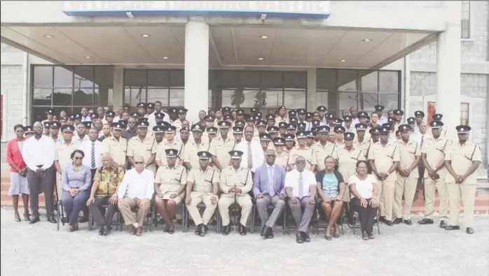  ??  ?? This police photo shows Police Service Commission Chairman Paul Slowe (seated fourth from right) with Police Commission­er Leslie James (seated fifth from right), the newly promoted personnel and other police officials.