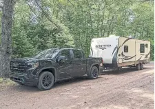  ??  ?? Using a GMC Sierra 1500 and a 25-foot rented trailer, Evan Williams went camping with his wife and dog.