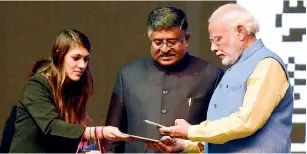  ?? PTI ?? Prime Minister Narendra Modi making payment through the newly launched mobile app ‘BHIM’ for a Khadi product during a Digidhan Mela at Talkatora Stadium in New Delhi on Friday. —