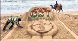  ??  ?? Sand artist Sudarshan Pattnaik creates a sand sculpture to welcome the launch of GST at Puri beach of Odisha on Friday.