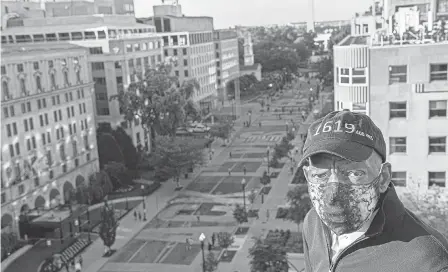  ?? KHALID NAJI- ALLAH/ EXECUTIVE OFFICE OF THE MAYOR VIA AP ?? Rep. John Lewis, wearing a 1619 hat marking the start of U. S. slavery, looks over the Black Lives Matter Plaza in Washington, D. C., last month.