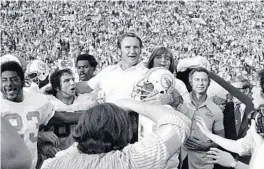  ?? AP ?? Coach Don Shula is carried off the field after his 1972 Miami Dolphins finished an unpreceden­ted perfect season with a victory over the Washington Redskins in the Super Bowl.