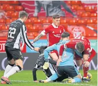  ??  ?? Saints keeper Jak Alnwick denies Lewis Ferguson