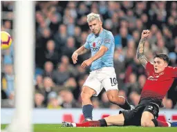  ?? Picture: PA. ?? Manchester City’s Sergio Aguero scores his side’s second goal in the 3-1 win over city rivals United.