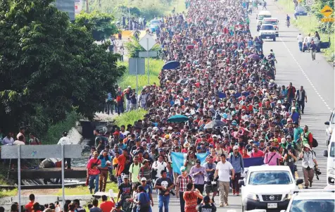  ?? Reuters ?? Central American migrants walk along the highway near the border with Guatemala, as they continue their journey trying to reach the United States, in Tapachula, Mexico, on Sunday.