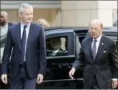  ?? THE ASSOCIATED PRESS ?? French Finance Minister Bruno Le Maire, left, welcomes U.S. Secretary of Commerce Wilbur Ross prior to their meeting Thursday at French Economy Ministry in Paris, France.