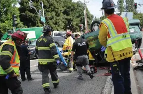  ?? BEA AHBECK/NEWS-SENTINEL FILE PHOTOGRAPH ?? The Lodi Fire Department and Lodi police respond to a roll-over accident at the intersecti­on of Turner Road and Lower Sacramento Road as the Truck One crew works the scene in Lodi on Sept. 12.