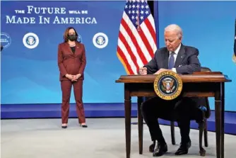  ?? AP PHOTO/EVAN VUCCI ?? President Joe Biden signs an executive order Monday on American manufactur­ing, in the South Court Auditorium on the White House complex.