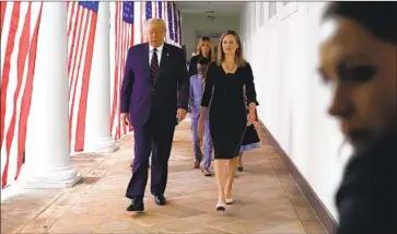  ?? Alex Brandon Associated Press ?? PRESIDENT TRUMP with Judge Amy Coney Barrett after what may have been a super- spreader event.