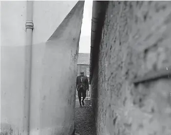  ??  ?? This photograph shows a man walking down the “Cat’s Close” in November 1968. It’s thought the name refers to the narrowness of the passage.