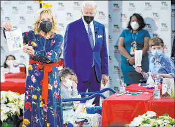  ?? Carolyn Kaster The Associated Press ?? First lady Jill Biden displays a lantern made by a patient at Children’s National Hospital as part of a winter craft project as she and President Joe Biden make a Christmas Eve visit Friday to patients in Washington.