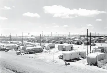  ?? COURTESY OF LANL ?? RIGHT: The Manhattan Project turned what had been a private boys school into the bustling secret city of Los Alamos.