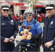  ?? ERIC E. FRANZ — CINCINNATI POLICE DEPARTMENT VIA AP ?? In this undated photo provided by the Cincinnati Police Department, officers pose for a photo in Cincinnati with a stuffed moose called Mr. Moosey. The Cincinnati Enquirer reports that the toy has become a traveling protection talisman sent to police...