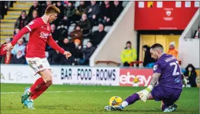  ?? ?? NOT THIS TIME: Ged Garner is thwarted by Sutton keeper Dean Bouzanis