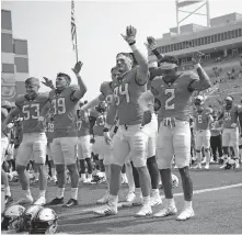  ?? [JOHN CLANTON/ TULSA WORLD] ?? Oklahoma State receiver Tylan Wallace (2) and his teammates gather for the alma mater after beating Tulsa on Saturday at Boone Pickens Stadium in Stillwater. OSU won the game 16-7.