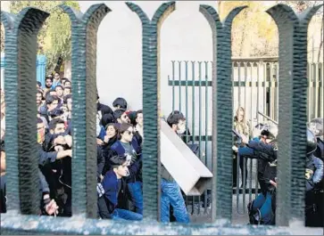  ?? EPA/Shuttersto­ck ?? STUDENTS clash with riot police at the University of Tehran. Thirteen people have been killed since demonstrat­ions began in Iranian cities on Thursday. Protesters have called for Iran’s top leaders to step down.