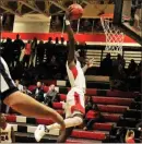  ?? (Contribute­d by Gail Conne ?? Trevon Wofford leaps dunks during last Friday’s home game against LaGrange.