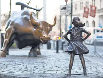  ?? MARK LENNIHAN, AP ?? Fearless Girl staked her claim in front of Charging Bull on the eve of Internatio­nal Women’s Day last month.