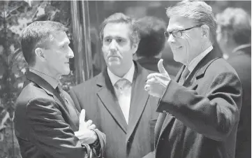  ??  ?? (From left) Retired Lt. Gen. Michael Flynn, Trump’s choice for National Security Advisor, Michael Cohen, executive vice president of the Trump Organisati­on and special counsel to Trump, and former Texas Governor Rick Perry talk with each other in the...