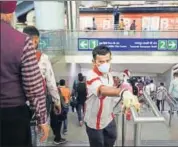  ??  ?? A DMRC staff member disinfects handrails at the Rajiv Chowk Metro station, in view of the coronaviru­s outbreak. RAJ K RAJ/HT PHOTO.