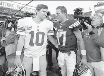  ?? Denis Poroy Associated Press ?? NEW YORK GIANTS’ Eli Manning (10) and the Chargers’ Philip Rivers were traded for each other after being drafted in the first round in 2004. Rivers will make his 211th consecutiv­e regular-season start Sunday.