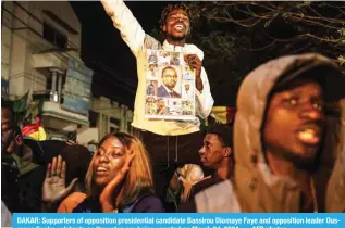  ?? ?? DAKAR: Supporters of opposition presidenti­al candidate Bassirou Diomaye Faye and opposition leader Ousmane Sonko celebrate as the votes are being counted on March 24, 2024. — AFP photos