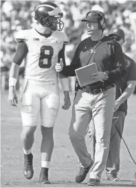 ?? BRIAN SPURLOCK, USA TODAY SPORTS ?? Michigan coach Jim Harbaugh talks with quarterbac­k John O’Korn.