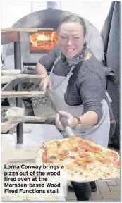  ??  ?? Lorna Conway brings a pizza out of the wood fired oven at the Marsden-based Wood Fired Functions stall
