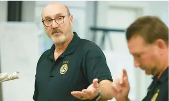  ?? STEPHEN M. DOWELL/ORLANDO SENTINEL ?? Rob McCloy, National Coordinato­r for Emergency Support Function 13, speaks to other agents at the Hyatt Place near Orlando Internatio­nal Airport on Oct. 4.