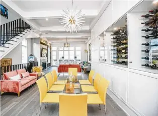  ?? Luis Urdaneta / Next Listing ?? A vintage ’70s-style dining table is surrounded by yellow leather chairs. It all sits in front of a wine niche built into the wall.