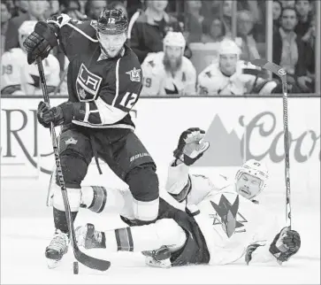  ?? Wally Skalij Los Angeles Times ?? MARIAN GABORIK (12) battles for the puck with San Jose’s Joonas Donskoi in the first period. The Kings were held to one goal — by Dustin Brown — after averaging three during their winning streak.